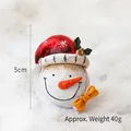 5cm Christmas snowman head figurine with red snowflake hat and orange bow decoration - Smiling Snowman