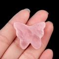 Pink rose quartz butterfly stone carving held by hand showing natural crystal texture - Rose Quartz / 30*35mm No Hole