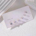 Set of 6 rose gold cubic zirconia stud earrings in varying sizes on a display card - Rose Gold (E1752-1)