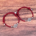 Detail of red braided couple bracelets with magnetic heart and tree of life charms - Wine Red Pair
