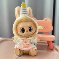 Labubu doll in pink overalls with cake embroidery and party hat from Sitting Party series - Pink Cake-style Overalls / First And Second Generation Keychains Are Compatible With La Cloth Dolls. Dolls Not Included.