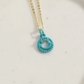 Gold chain necklace with teal blue smiley face pendant and beaded trim detail - Blue