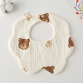 Detailed macro of a soft gauze cotton baby bib featuring brown bear and paw prints - Gauze Flower Scarf - Coffee Bear