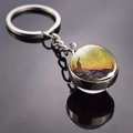 Detail of silver metal keychain featuring Van Gogh Starry Night art in glass dome - Wheat Field
