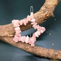 Macro shot of a star-shaped hair clip with pink natural crystal stones on a wooden branch - Rose Quartz Star Hair Clip