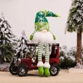 Green and white striped Christmas gnome doll sitting on a red vintage metal toy car - Long Leg with LED / Green