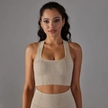 Detailed macro view of seamless ribbed knit texture on champagne sports bra and leggings - Beige AB