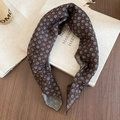 Close-up of a dark brown floral silk scarf on a vintage book with retro french style - Headscarf - Brown - Style 2