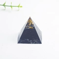 Black resin energy pyramid with gold leaf and natural crystal stone for office desk - Obsidian