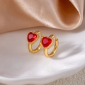 Detail view of gold hoop earrings featuring faceted red heart crystals and milgrain edges - Heart Zirconia / Red