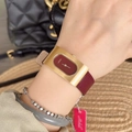 Elegant women's watch with red leather strap and golden rectangular case on wrist - Square Steel Case