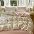 Floral print duvet cover set in pink and yellow tones on a bed with soft lighting - Orange Yellow Floral
