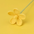 Close-up of a handmade crochet flower with yellow petals and a light green stem - Yellow
