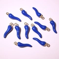 Close-up of dark blue enamel chili pendants with gold loops for DIY jewelry making - Dark Blue