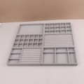 Macro detail of various grey velvet jewelry tray inserts with multiple compartments - Combination Style / Gray