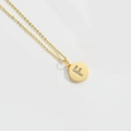 Minimalist gold necklace featuring a circular pendant with a sparkling zircon letter F - Letter F