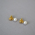 Close-up of gold-plated brass ear studs with natural freshwater pearls and silver needles - Gold