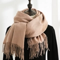Soft camel cashmere-like scarf with long fringe details draped on a neck model - Nude Yellow