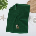 Dark green cotton Christmas towel featuring a cute reindeer embroidery on a white surface - Christmas Reindeer / Green
