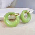Close-up of green oval hoop earrings with 18K gold plated hinges on white marble background - Gold-Green