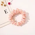 Close-up of a pink satin scrunchie with soft fabric pleats and elegant silk luster - Satin Thin Scrunchie-Snow Bud