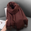Soft dark brown imitation cashmere scarf with tassels shown in a cozy home setting - 68x180cm / Coffee