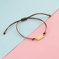Adjustable brown braided bracelet with a polished gold stainless steel bar detail - Gold Brown Rope
