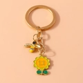 Portachiavi in metallo dorato con ape e girasole smaltati su sfondo rosa chiaro - Giallo