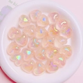 Luminous heart-shaped Aurora beads in a white ceramic dish for DIY craft projects - 1 Bead / Light Orange