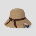 Detail of handwoven straw sun hat texture with UV protection label and ribbon - M (56-58cm) / Brown