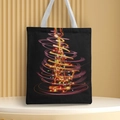 Close-up of black canvas tote bag with a glowing Christmas tree print and white handles - Style 13