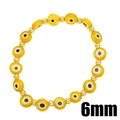 Dettaglio macro di perline occhio turco gialle da 6mm e distanziatori dorati - Giallo
