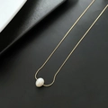 Elegant gold titanium necklace featuring a natural white pearl pendant on textured surface - 04-K14 Natural White Small Pearl Necklace