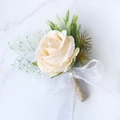 Champagne rose boutonniere with green leaves, white bow and pearl on marble base - Champagne Boutonniere