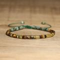 Detailed close-up of tiger eye and turquoise beads with adjustable woven strap - No.97 Tiger Eye African Turquoise Gold