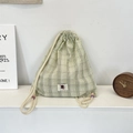 Detail of green plaid drawstring backpack with cartoon cat patch and colorful beads - Fruit Green