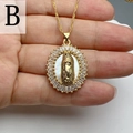Macro shot of gold Virgin Mary pendant with baguette crystals and white pearl base - Style B-Virgin of Guadalupe Mother of Pearl