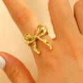 Minimalist gold bow-shaped stainless steel open ring for women on finger - Flowing Ribbon Bow Style (N-829)