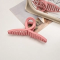 Close-up of pink matte hair claw clip showing textured finish and spring mechanism - Cross / Girl Pink