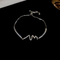 Macro shot of adjustable silver bracelet with zircon-encrusted heartbeat design on black background - Heartbeat Style / Silver Heartbeat
