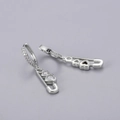 Detail of S925 silver huggie earrings with safety pin pendant and heart zirconia - Heart Safety Pin Earrings - Silver