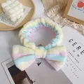 Rainbow striped coral fleece headband with a large bow for skincare and makeup routines - Rainbow Stripe