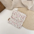 Detailed view of a small floral fabric organizer pouch with a pink snap button closure - Large / Pink