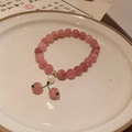 Detailed shot of pink crystal bead bracelet with shell pearl on a ceramic tray - Style 25 Pink Beaded (Artificial Pearl)