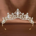 Macro shot of bridal crown featuring golden filigree patterns and sparkling rhinestones - Gold