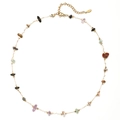 Detailed macro view of a gold stainless steel chain necklace with colorful natural stones - Colorful