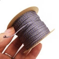 Detail of 1mm purple gold braided cord wrapped on kraft paper roll for DIY bracelets - Light Purple