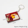 Miniature bento box keychain with realistic food models and dimensions 4.7x3.5x1cm - Sausage Rice Bento