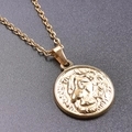 Close-up of gold stainless steel necklace featuring a round lion head relief pendant - Necklace / Gold