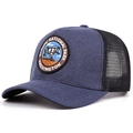 Detail view of Olympic National Park embroidery and breathable mesh on a retro trucker hat - Adjustable / Navy Blue